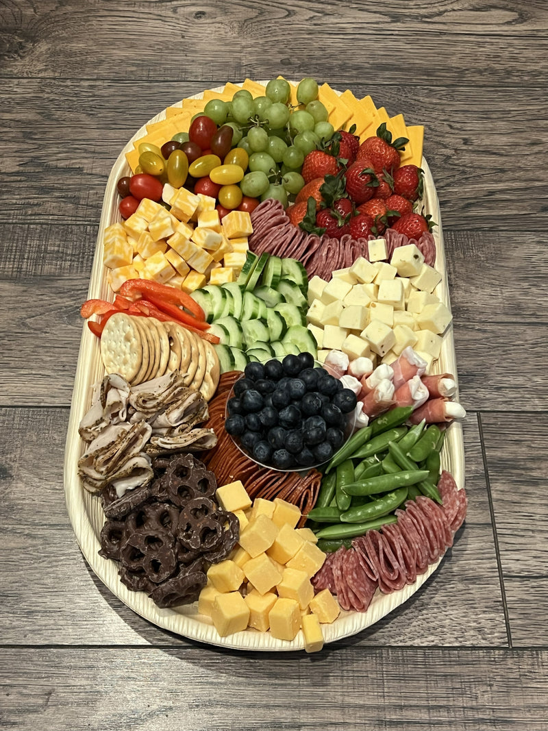 Customized charcuterie board for small group catering needs.   Meats, cheeses, fruits, veggies, crackers, and chocolate covered pretzels.  