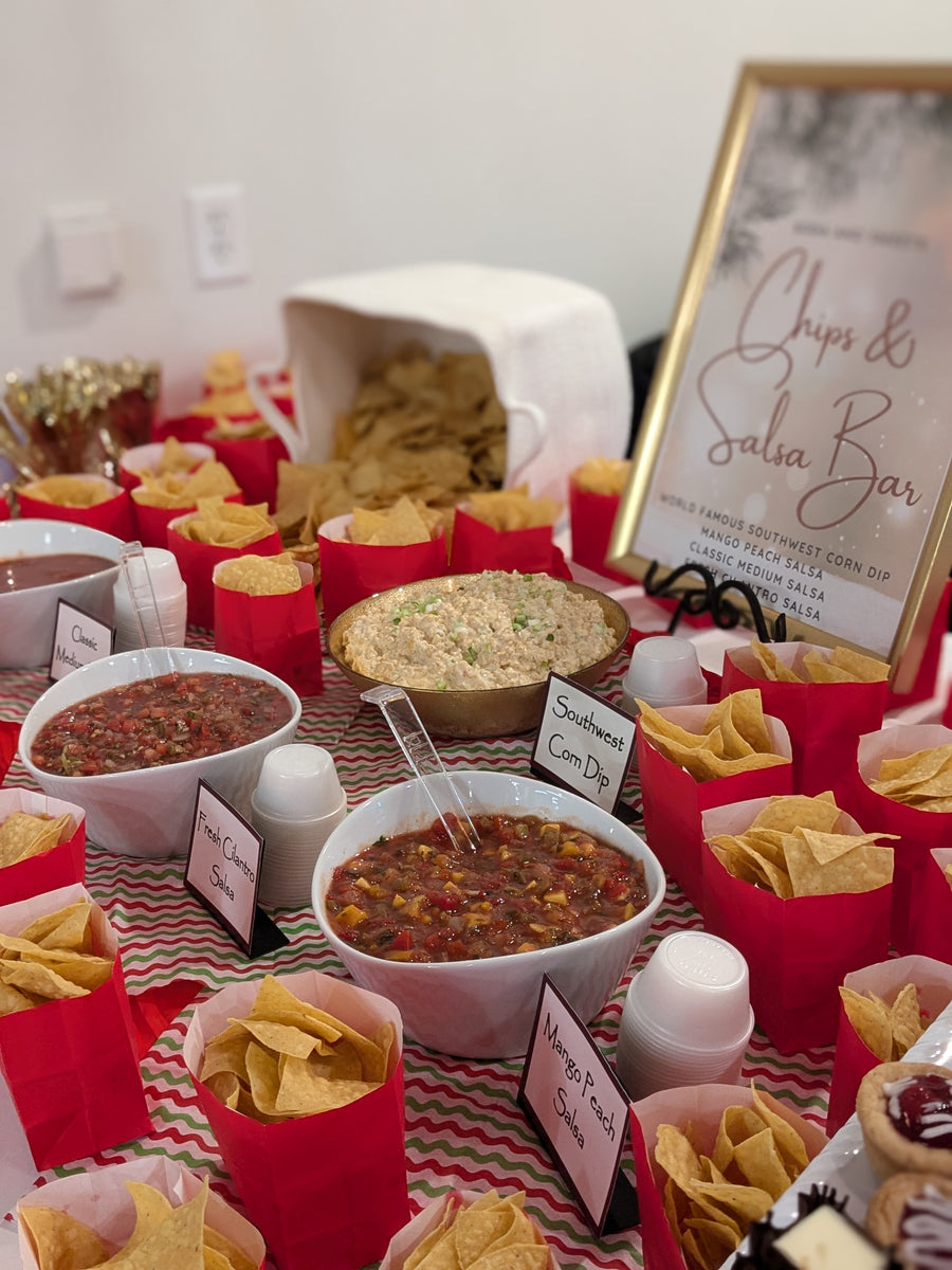 Chips and salsa displayed on a large festive table.  