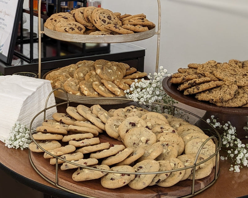 Table with various types of cookies and decorative elements in a room setting.