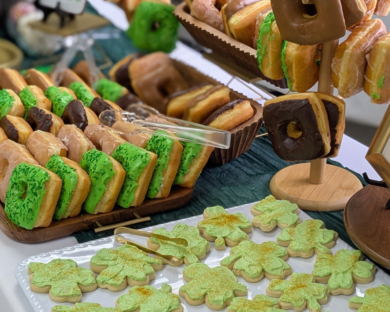 St. Patrick's themed donuts, cookies on a large platter dn displays.  