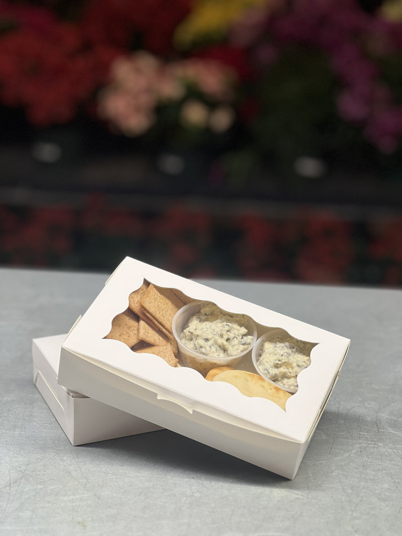 Small group catering boxes customized to tastes and needs.  Small white box with a variety of breads, crackers, and dips