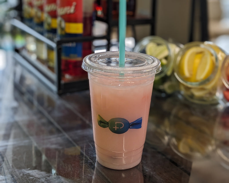 Custom branded soda blended with custom soda flavors and syrups in a clear cup with a corporate logo on the cup.  