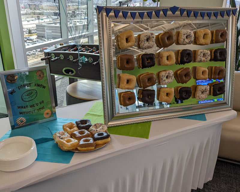 Donut display with a mirror on a table in an indoor setting