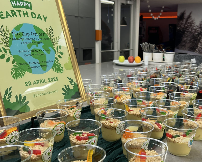 Happy Earth Day "worm cups" consisting of pudding in clear cup with toppings like gummy worms, crumbled cookies, granola.  