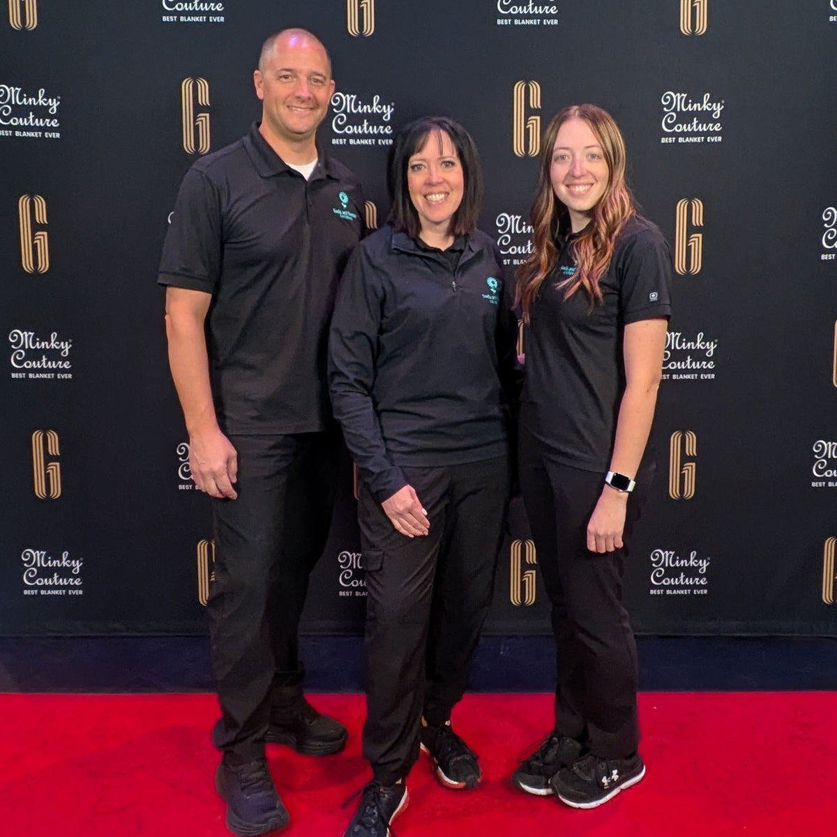 Two people standing in front of promotional posters for 'General Christmas' on a red carpet.