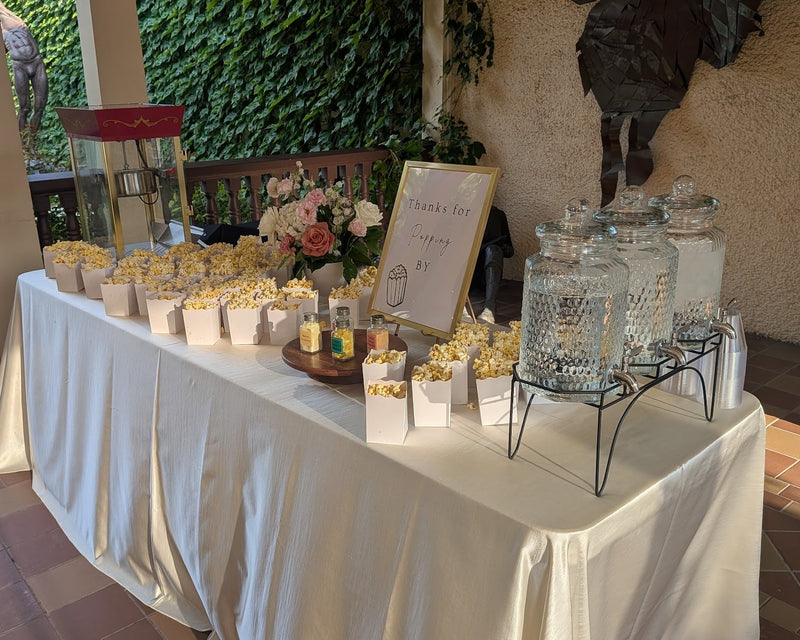 Freshly popped popcorn in boxes on a table.  