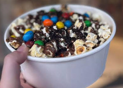 new product offering that is a popcorn bowl that allows the parton to add toppings such as chocolate sauce, caramel sauce, candy toppings, marshmallows to create a unique popcorn treat.