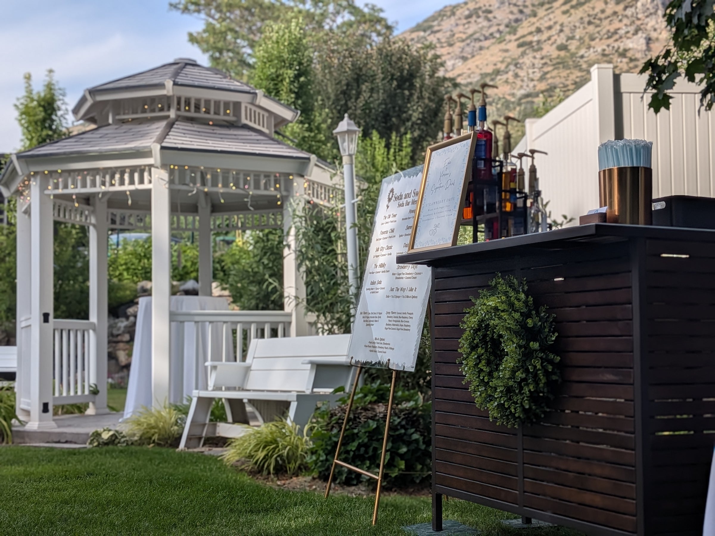 Soda bar in Utah setup in a scenic setting with a white gazebo to the side.  Soda bar includes flavored syrups to make customized flavored sodas.  