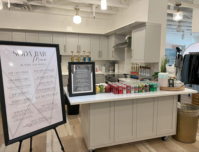 Soda bar.  Serving bar setup with flavored soda drink menus, cups, and decorative wreath.