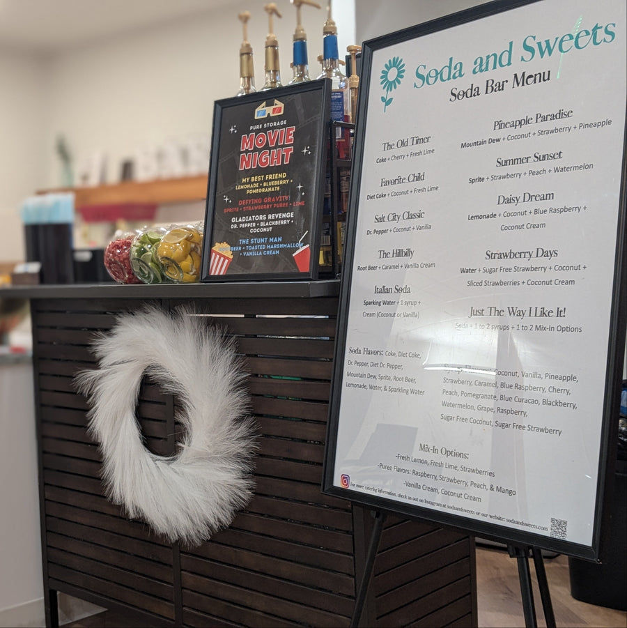 Soda bar with menu board and decorative wreath in a casual setting.  Specialty themed event specifically customized to the client's needs.  